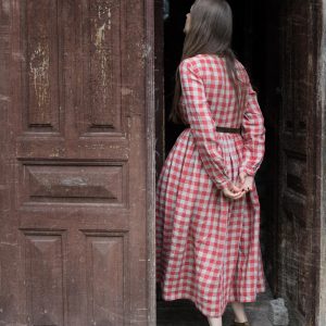 Red gingham linen smock dress with long sleeves and a gathered skirt.   in size m