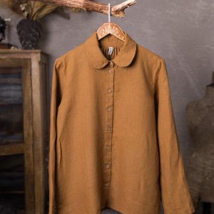 Warm brown linen shirt shown full-length from the front on a wooden hanger, with a rounded collar, long sleeves, a narrow button placket, small round buttons and a gently curved hem.